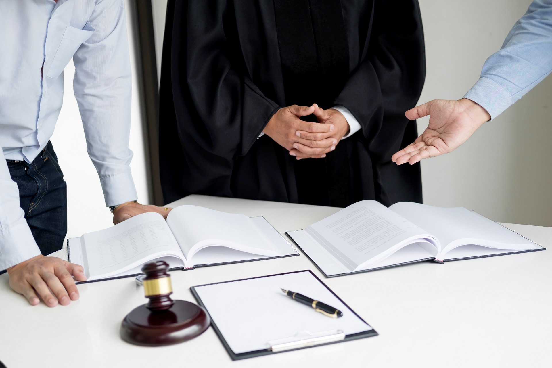 business people and lawyers discussing contract papers sitting a