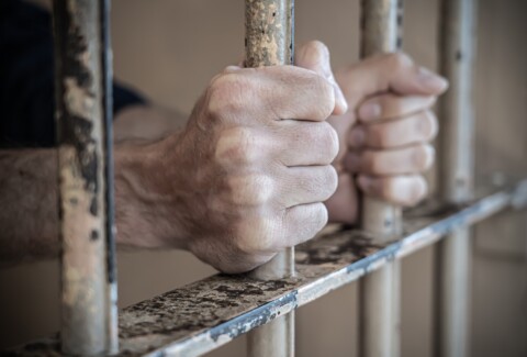 Close up of prisoner hands in jail