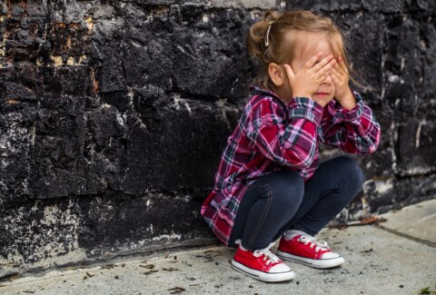 little beautiful girl near brick wall