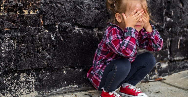 little beautiful girl near brick wall