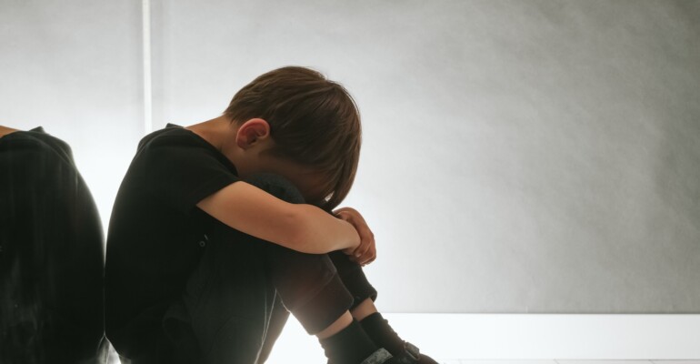 child whose depression is sitting on the floor