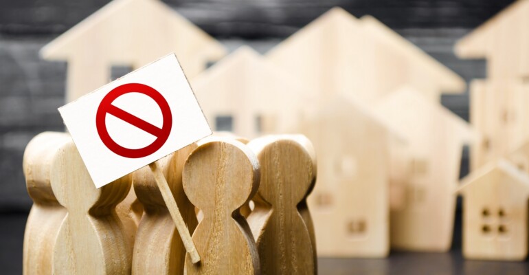 A group of people with posters demonstrate protest. The struggle for rights and freedom, rejection of anti-peoples laws and reforms. An angry mob. Political movement. Social discontent, tension.