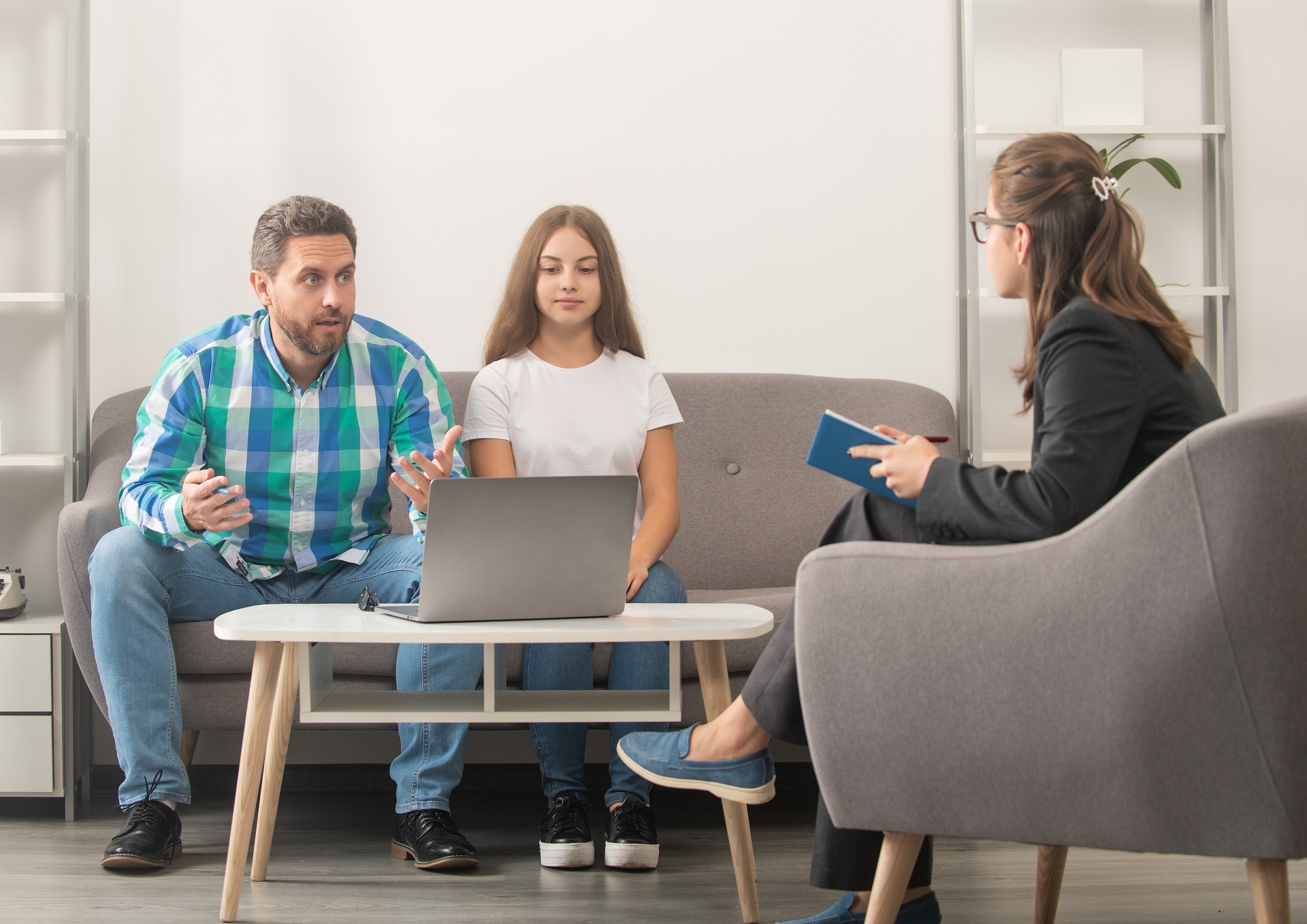 father and child at psychologist session. family therapy. parent-teacher meeting.